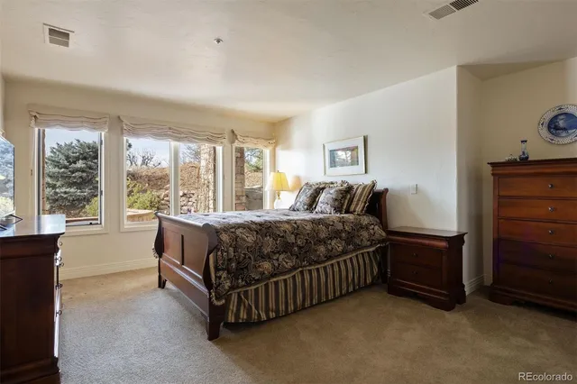 a bathroom with a granite countertop sink a toilet and a mirror