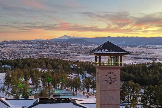 an aerial view of a house with a garden and lake view