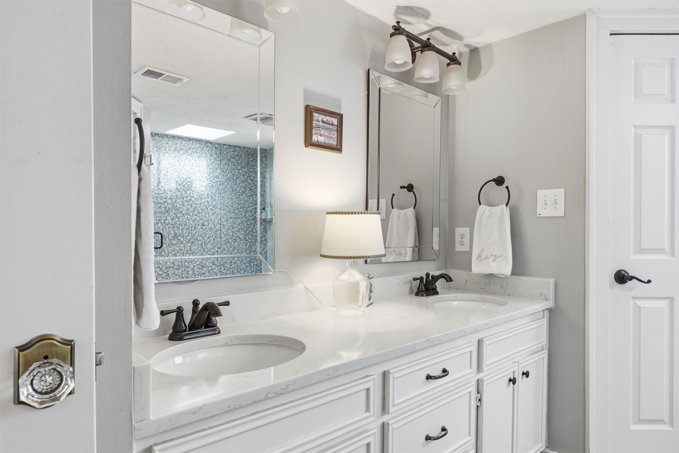 1507 Wethersfield Road Austin, TX 78703 - Photo 23 of 40 a bathroom with a sink and a mirror