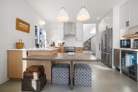 a living room with furniture a lamp and a potted plant