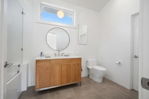 a view of a wooden door with a chair and table in front of house