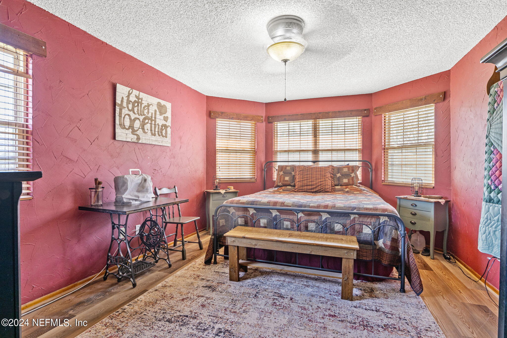 5641 Ricker Road Jacksonville, FL 32244 - Photo 19 of 33 a bedroom with a bed and a chandelier