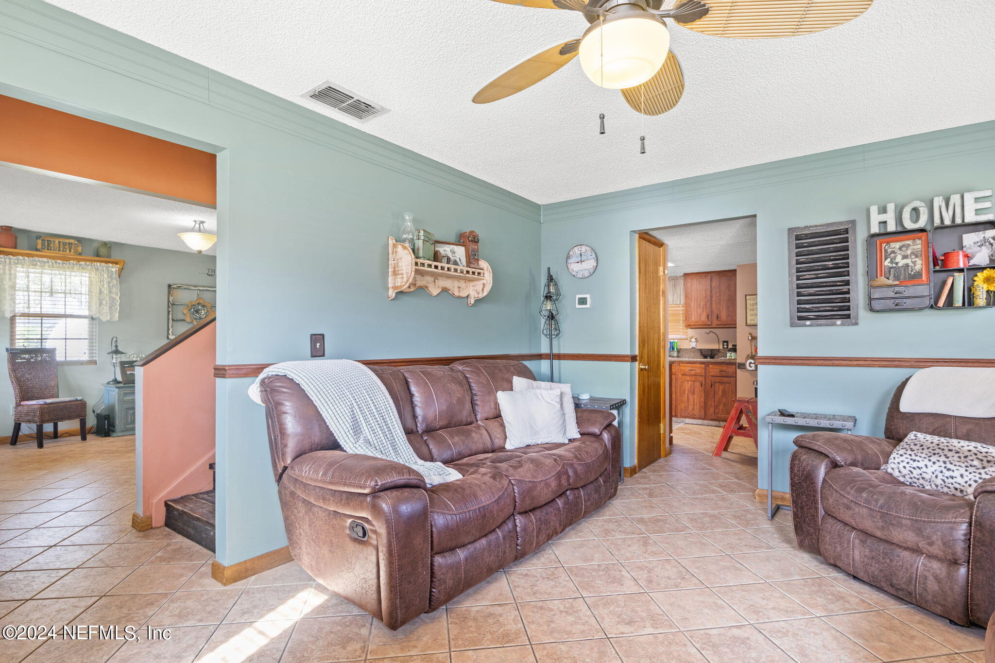 5641 Ricker Road Jacksonville, FL 32244 - Photo 9 of 33 a living room with furniture and a chandelier