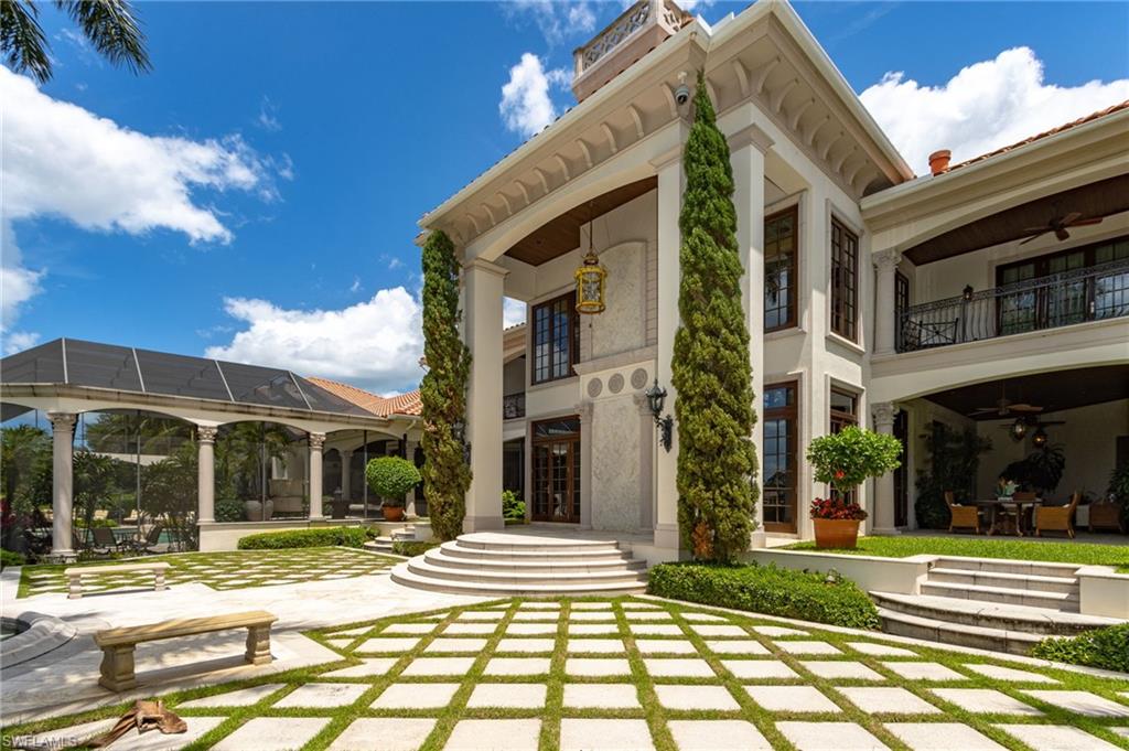 14928 Celle Way Naples, FL 34110 - Photo 11 of 35 a view of a brick building next to a yard