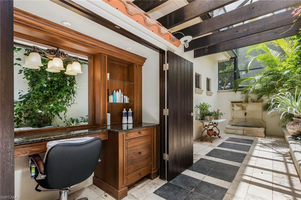 14928 Celle Way Naples, FL 34110 - Photo 12 of 35 a view of a porch with chairs and a potted plant