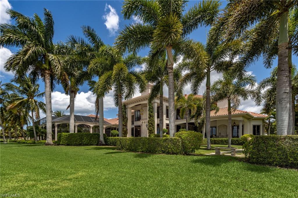 14928 Celle Way Naples, FL 34110 - Photo 13 of 35 a view of a big yard next to a house