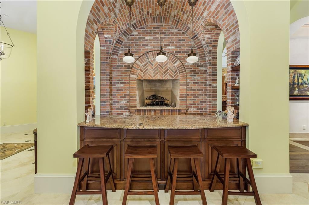 14928 Celle Way Naples, FL 34110 - Photo 21 of 35 a kitchen with a table and chairs in it