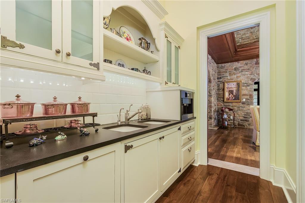 14928 Celle Way Naples, FL 34110 - Photo 26 of 35 a bathroom with a sink and a mirror