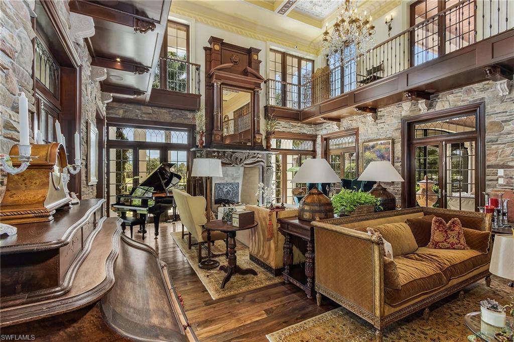 14928 Celle Way Naples, FL 34110 - Photo 27 of 35 a view of a patio with couches table and chairs and potted plants