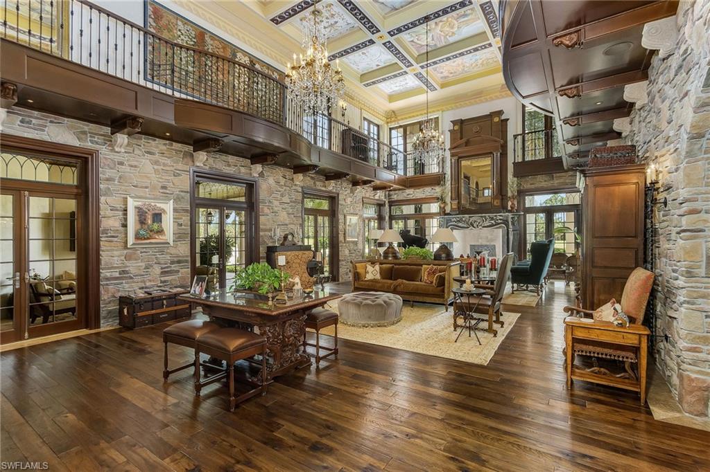 14928 Celle Way Naples, FL 34110 - Photo 28 of 35 a building outdoor space with patio furniture and wooden floor