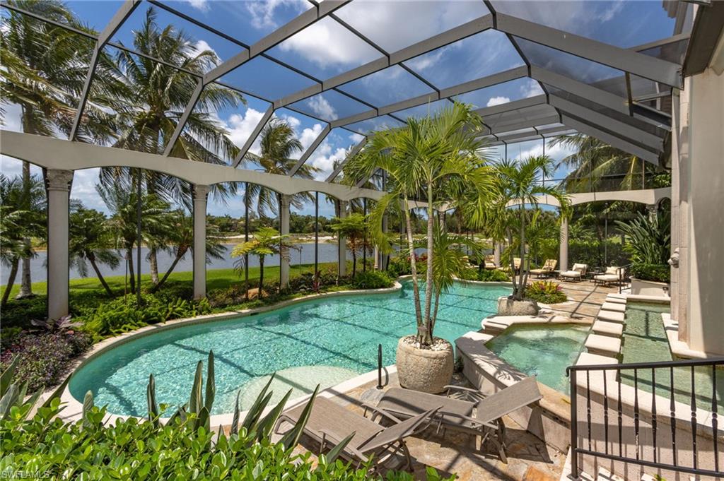 14928 Celle Way Naples, FL 34110 - Photo 5 of 35 a view of a patio with table and chairs potted plants and palm trees