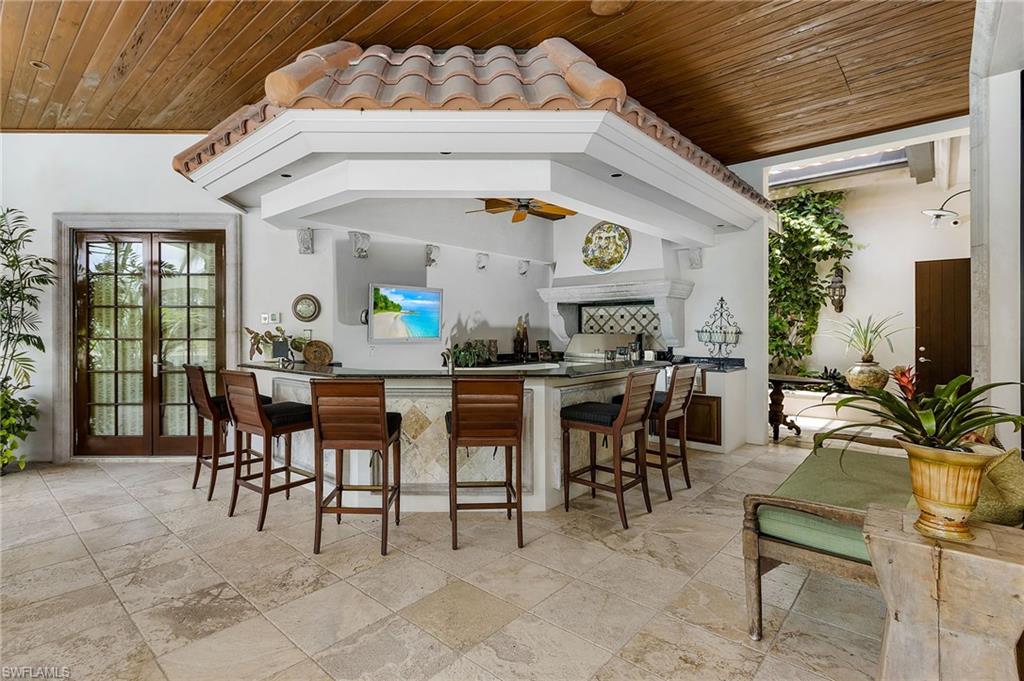 14928 Celle Way Naples, FL 34110 - Photo 7 of 35 a view of a dining room with furniture and chandelier