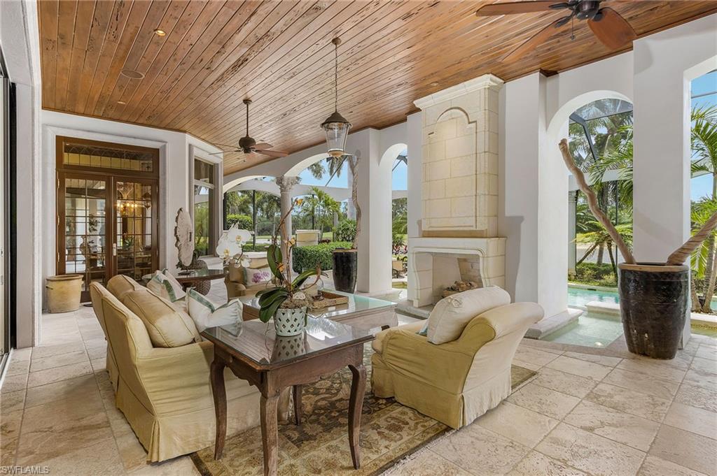 14928 Celle Way Naples, FL 34110 - Photo 8 of 35 a view of a patio with couches table and chairs and potted plants