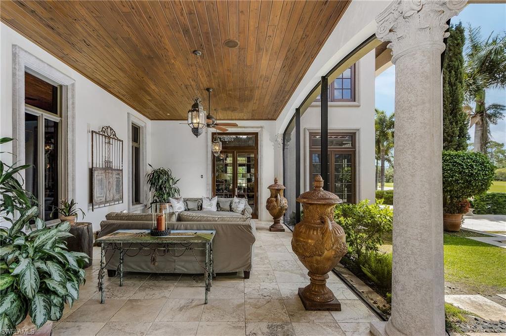 14928 Celle Way Naples, FL 34110 - Photo 10 of 35 a living room with furniture and a potted plant