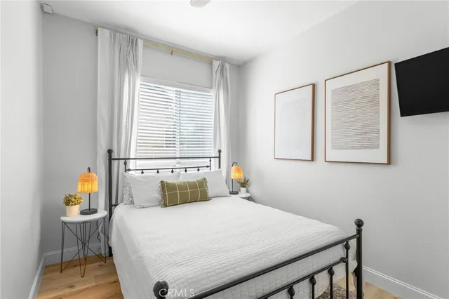 a bedroom with a bed and wooden floor