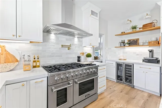 a kitchen with white cabinets and appliances