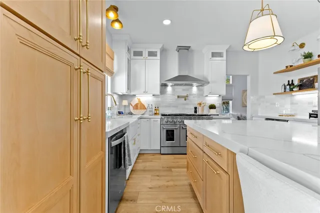 a kitchen with stainless steel appliances granite countertop a sink a stove and a refrigerator