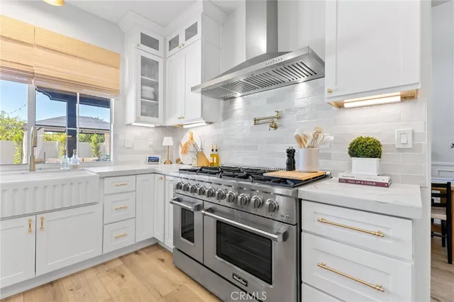 a kitchen with stainless steel appliances granite countertop a stove and a sink