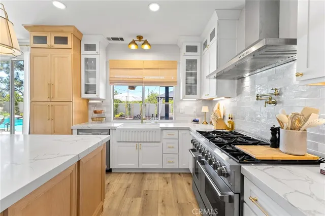 a kitchen with a sink stove and cabinets