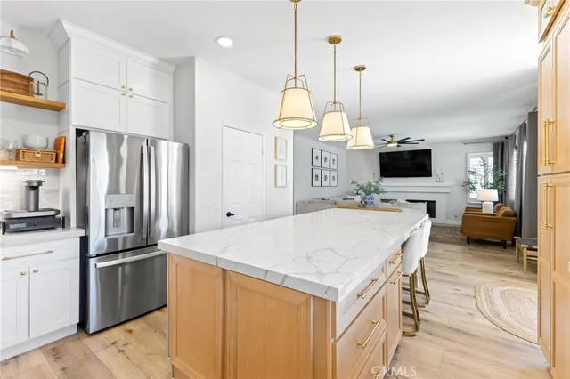 a kitchen with stainless steel appliances a stove refrigerator sink and microwave