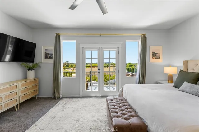 a bedroom with a bed and flat screen tv