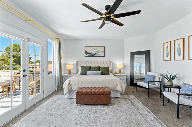 a bedroom with a large bed couch and a window