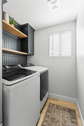a view of a kitchen with wooden floor and a window