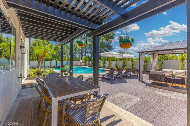 a view of a patio with a table chairs and a backyard