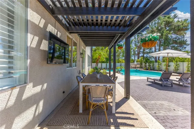 a view of a patio with a table chairs and a yard