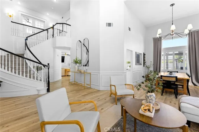 a living room with furniture a fireplace and a chandelier
