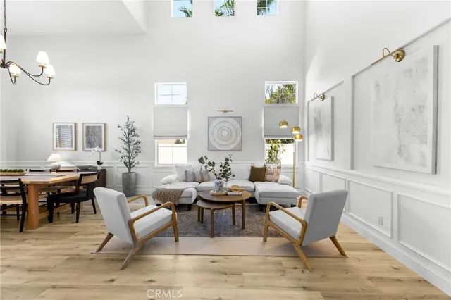 a living room with furniture a clock and a window