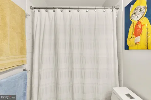 a bathroom with a shower curtain and curtain