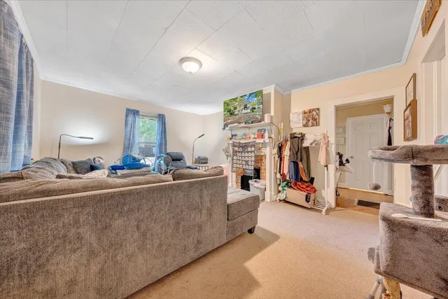 a room with lots of white furniture and a chandelier