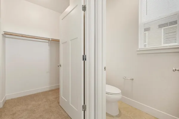 a bathroom with a granite countertop toilet and a shower