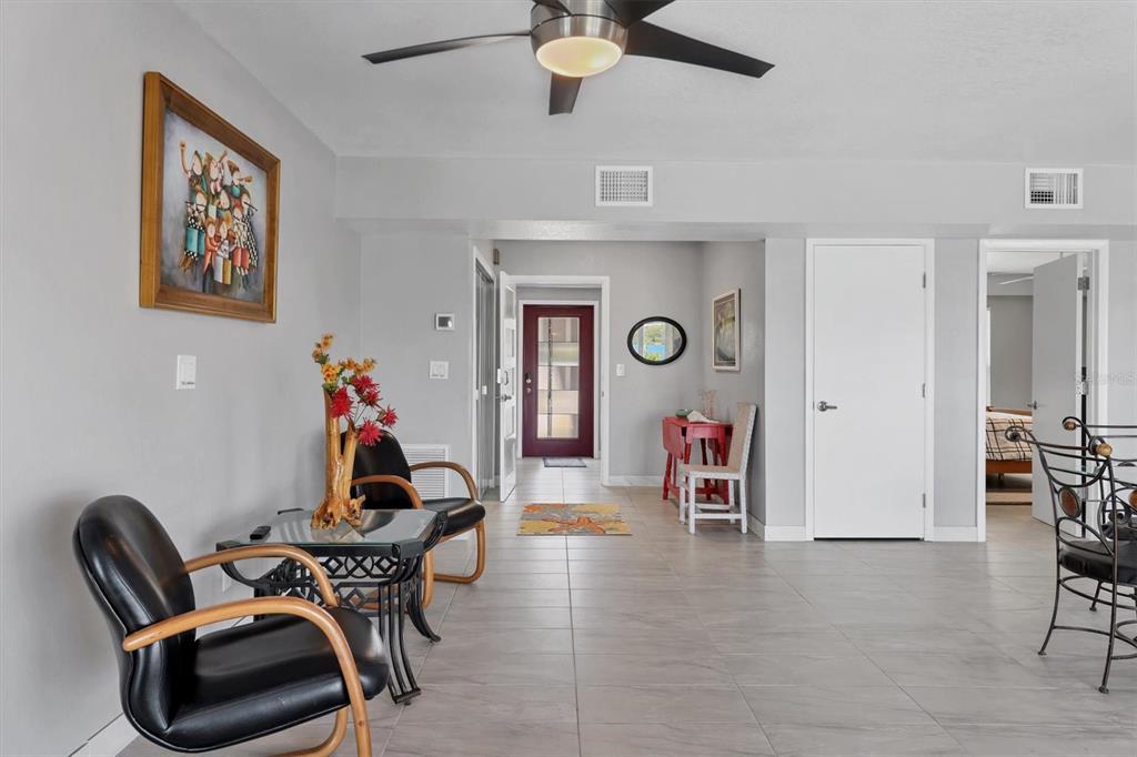 7985 Manasota Key Road Englewood, FL 34223 - Photo 41 of 83 a living room with furniture and a flat screen tv