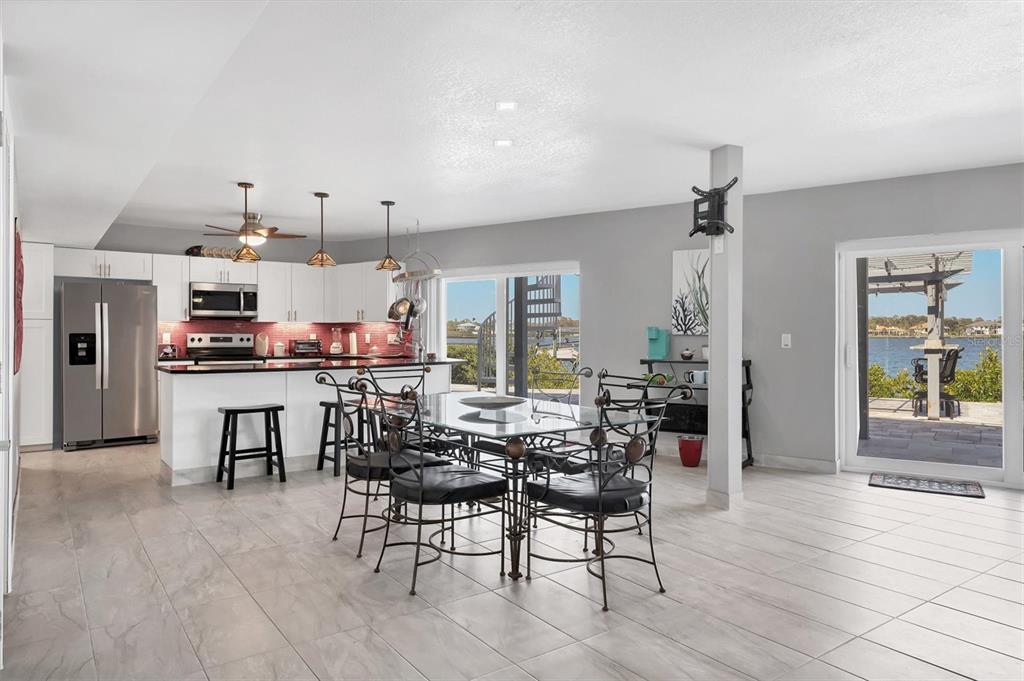 7985 Manasota Key Road Englewood, FL 34223 - Photo 46 of 83 a room with stainless steel appliances kitchen island granite countertop furniture and a living room