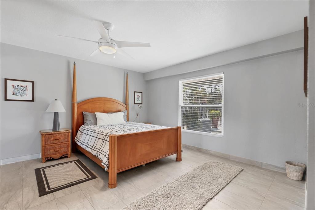 7985 Manasota Key Road Englewood, FL 34223 - Photo 54 of 83 a bedroom with a bed lamp and window