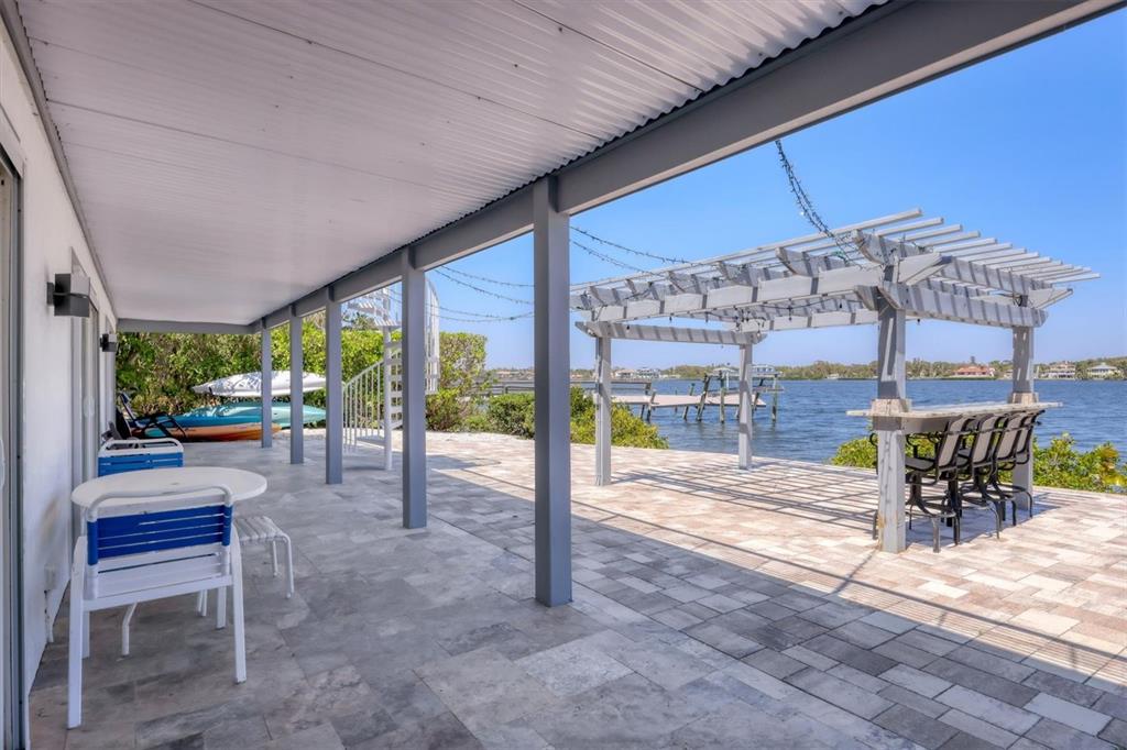 7985 Manasota Key Road Englewood, FL 34223 - Photo 65 of 83 a view of a patio with a table chairs and backyard