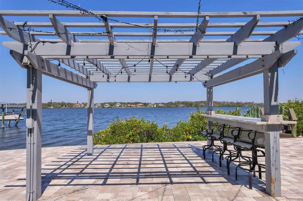 7985 Manasota Key Road Englewood, FL 34223 - Photo 66 of 83 a view of a patio with table and chairs potted plants