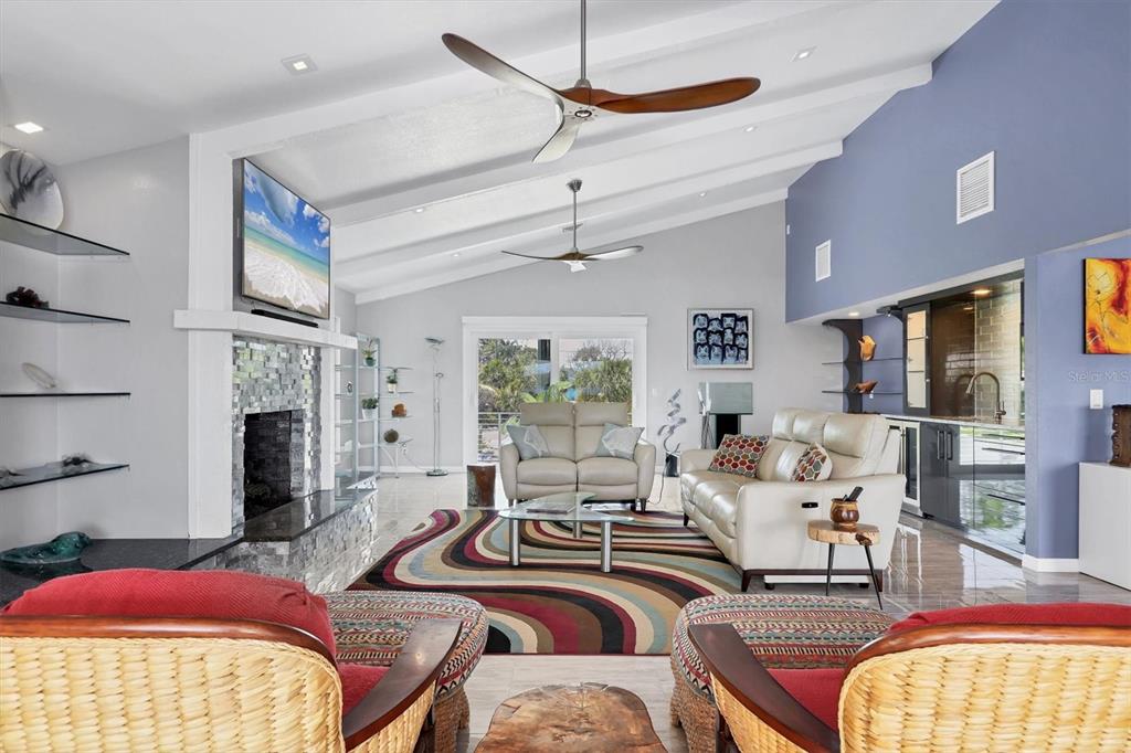 7985 Manasota Key Road Englewood, FL 34223 - Photo 7 of 83 a living room with furniture fireplace and flat screen tv