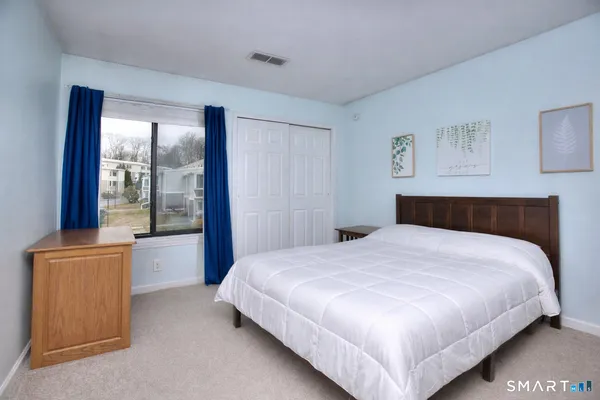 a bedroom with a large bed and a window