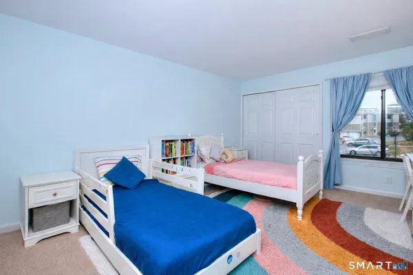 a bedroom with furniture and a large window