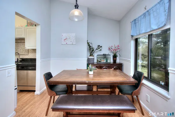 a view of a dining room with furniture and wooden floor