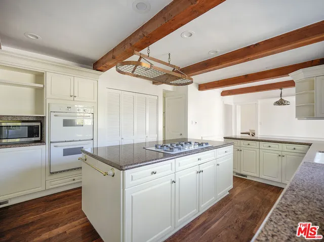 a kitchen with a sink stove and refrigerator