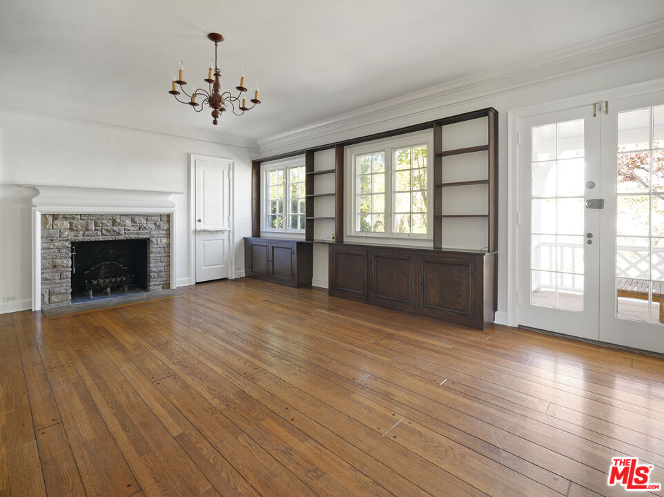 13161 Addison Street Sherman Oaks, CA 91423 - Photo 14 of 34 wooden floor fireplace and windows in an empty room