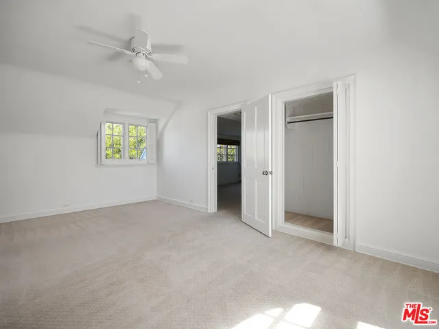 an empty room with windows and closet