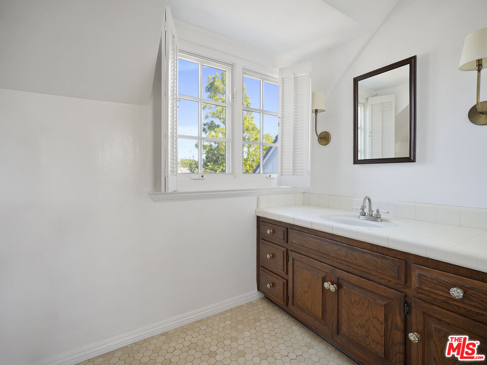 13161 Addison Street Sherman Oaks, CA 91423 - Photo 24 of 34 a bathroom with a sink and a mirror