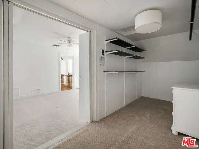 a view of a room with wooden floor and windows