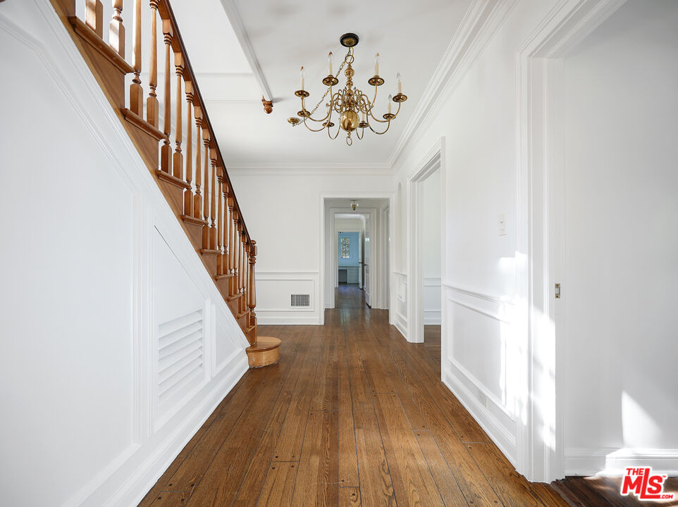 13161 Addison Street Sherman Oaks, CA 91423 - Photo 27 of 34 a view of a hallway with wooden floor and staircase