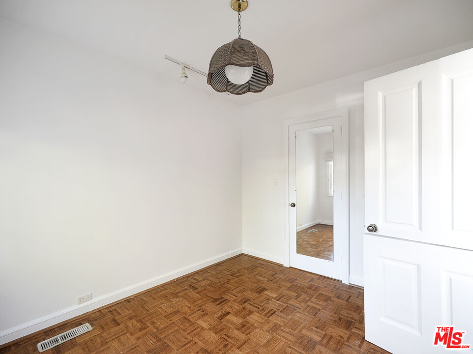 13161 Addison Street Sherman Oaks, CA 91423 - Photo 28 of 34 a view of a room with wooden floor and windows